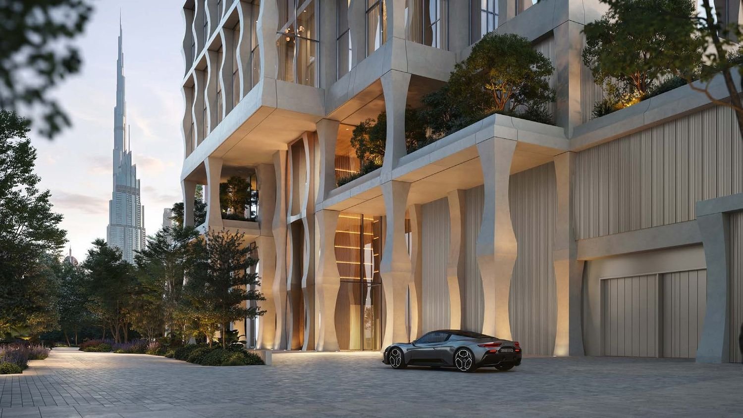 The sculpted colonnade at the residential arrival, with the Burj Khalifa beyond