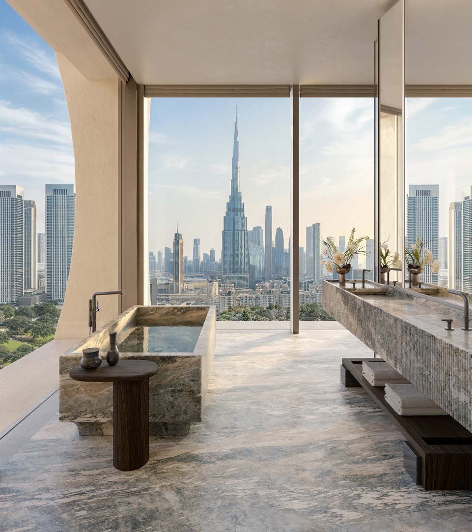 Master ensuite bathroom in book-matched stone, with Burj Khalifa views